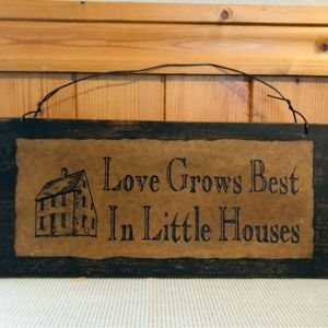 Rustic wooden  sign “Love Grows Best  in Little House’s”